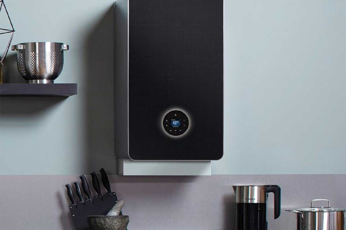 Gas Safe engineer fitting a wall-mounted boiler