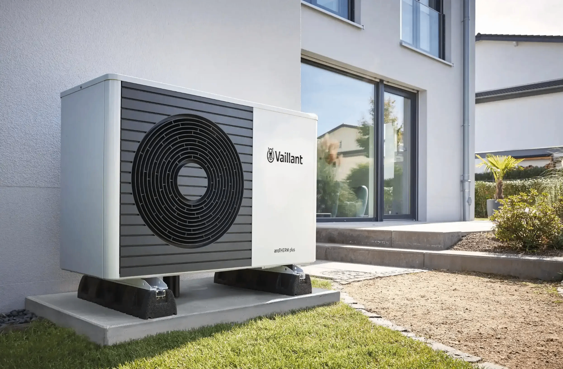 Heat pump installed beside a stone-walled UK home